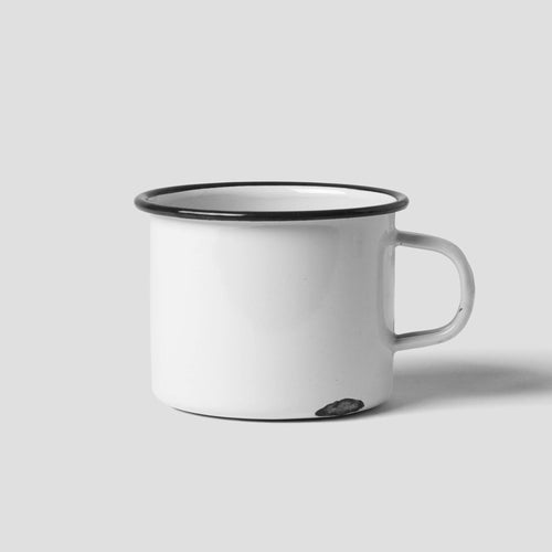 White enamel mug on grey background
